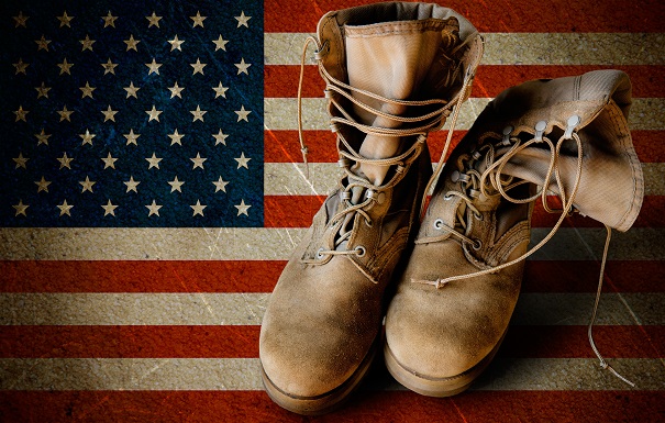 20386335 - grunge us army boots on sandy american flag background collage