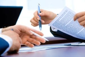 Person holding pen and paper