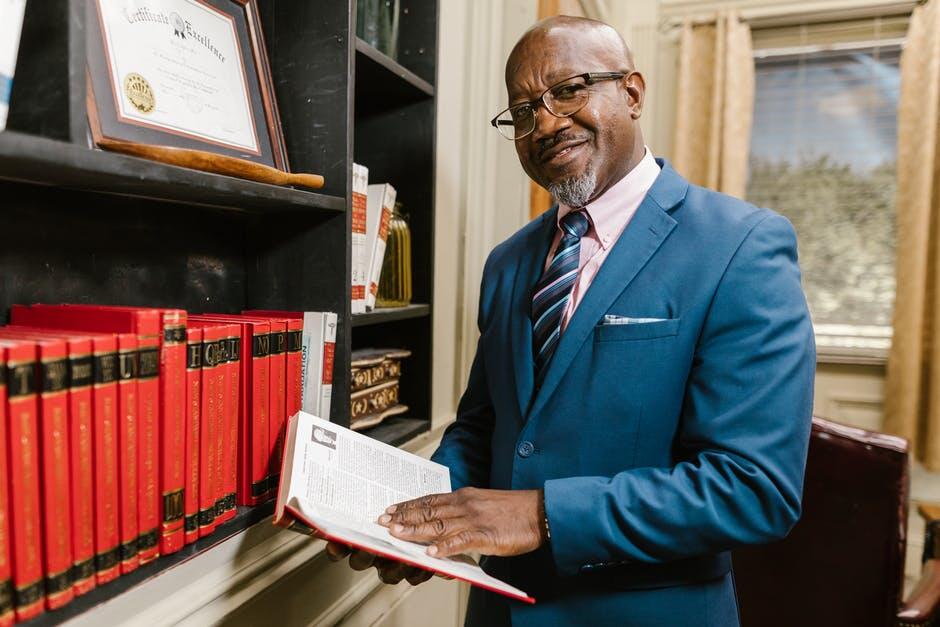 defense base act attorney defense base act attorney holding book